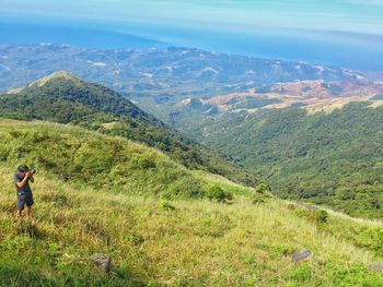 High angle view of landscape against sea and mountains