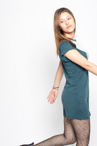 Portrait of smiling young woman against white background