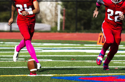 Low section of boy running on grass