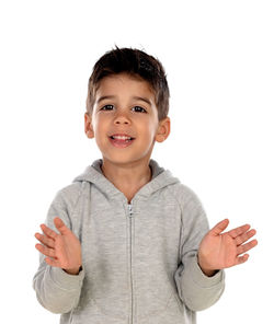 Portrait of smiling boy standing against white background