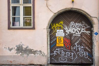 Graffiti on door of old building