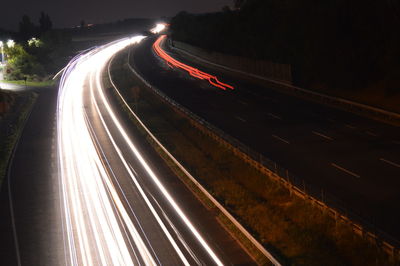 High angle view of light trails on road at night