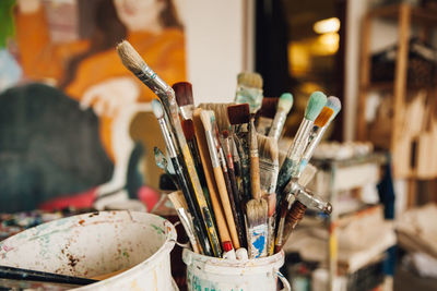 Close-up of paintbrushes in jar on table