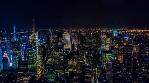 Aerial view of city lit up at night