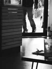 Low section of woman standing on wooden floor