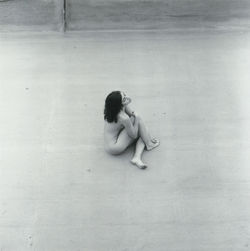 High angle view of woman sitting on floor against wall