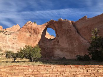 Rock formations against cloudy sky