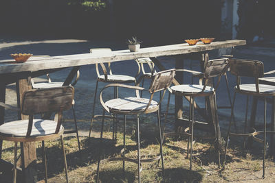 Empty chairs and tables at sidewalk cafe