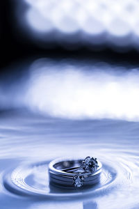 Close-up of wedding rings on table