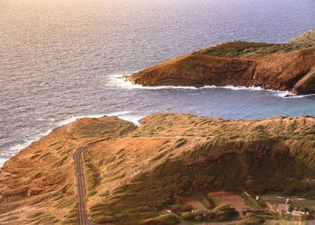 Scenic view of land by sea