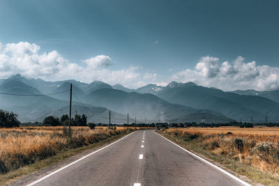 Diminishing road towards mountain range