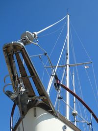 Low angle view of sailboat against blue sky