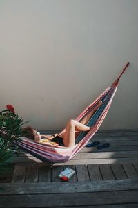 Woman relaxing in hammock at home