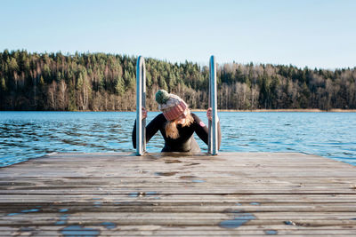 Woman looking happy whilst swimming in cold water ice swimming