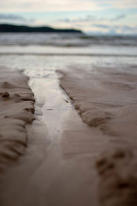 Surface level of beach against sky