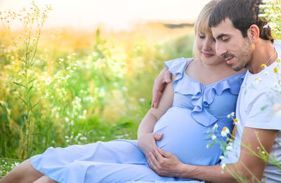 Couple sitting in field