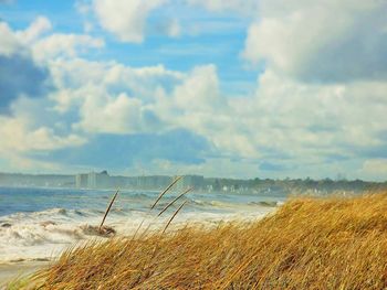 Scenic view of sea against cloudy sky