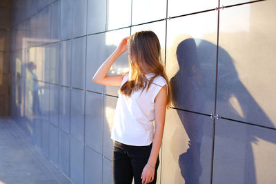 Rear view of woman standing in bathroom