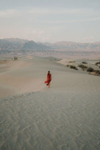 Person on desert against sky