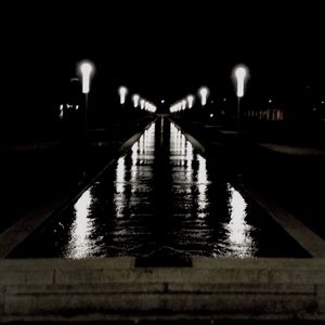 Illuminated bridge at night