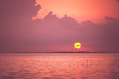 Scenic view of sea against romantic sky at sunset