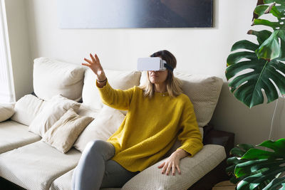 Woman sitting on sofa at home