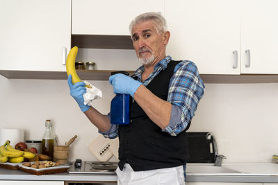 Man holding camera at home