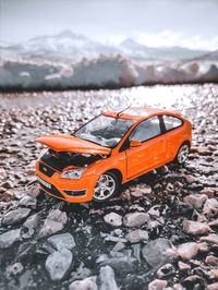 Toy car on snow covered mountain