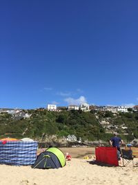 Tent on beach against clear blue sky