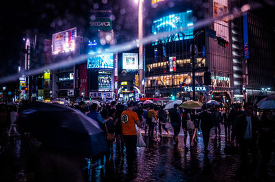 Crowd on road in city at night