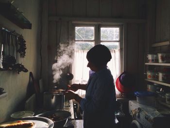 View of woman cooking in kitchen