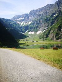 Road leading towards mountains against sky