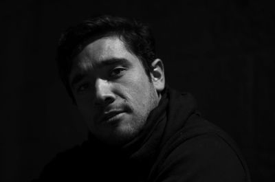 Portrait of young man on black background