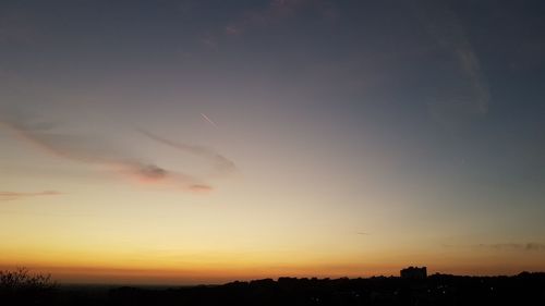 Low angle view of silhouette trees against sky during sunset