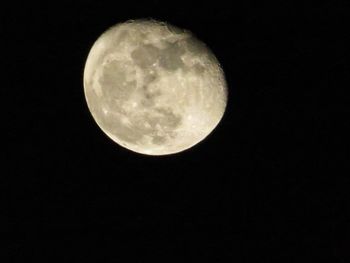 Low angle view of full moon against clear sky at night