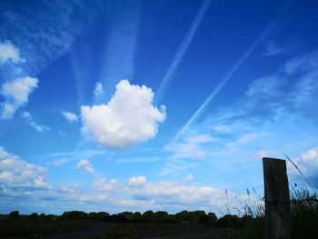 Scenic view of field against blue sky