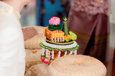 Midsection of woman holding cake