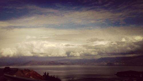 Scenic view of mountains against cloudy sky