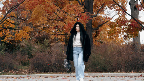 Rear view of woman standing on field
