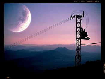 Low angle view of electricity pylon against sky