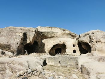 Rock formation against clear blue sky