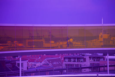Illuminated building seen through glass window at night