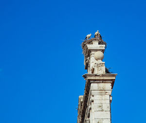 Low angle view of statue against blue sky