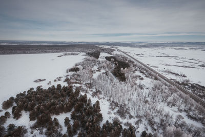 Scenic view of snow covered landscape against sky