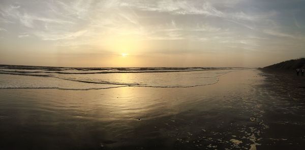 Scenic view of beach against sky during sunset