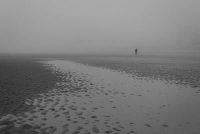 Scenic view of sea against foggy sky