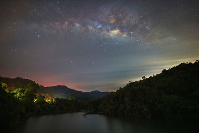 Scenic view of mountains against sky at night