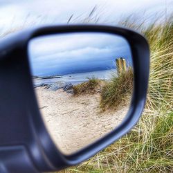 Reflection of sky on side-view mirror