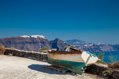 Old boat on the top of a cliff in santorini island in a beautiful early spring day