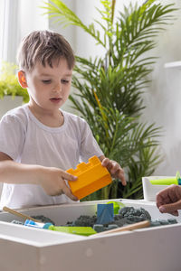 Portrait of boy eating food at home